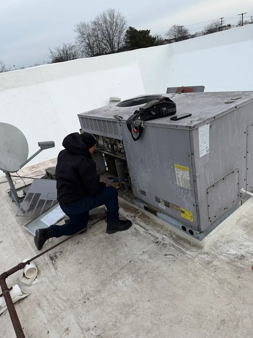 VIP technician repairing a rooftop HVAC unit